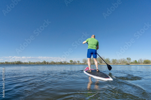 stand up paddling on a lake