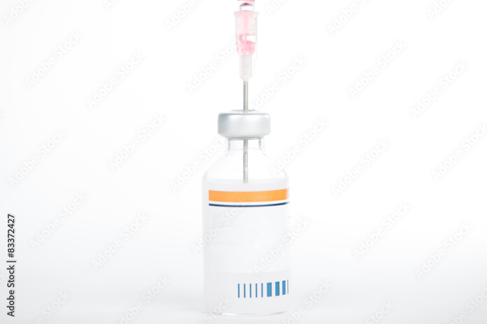 Injection preparation with vial and syringe on white Injection preparation with vial and syringe on white