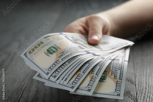 female hand hold bunch of dollars, closeup