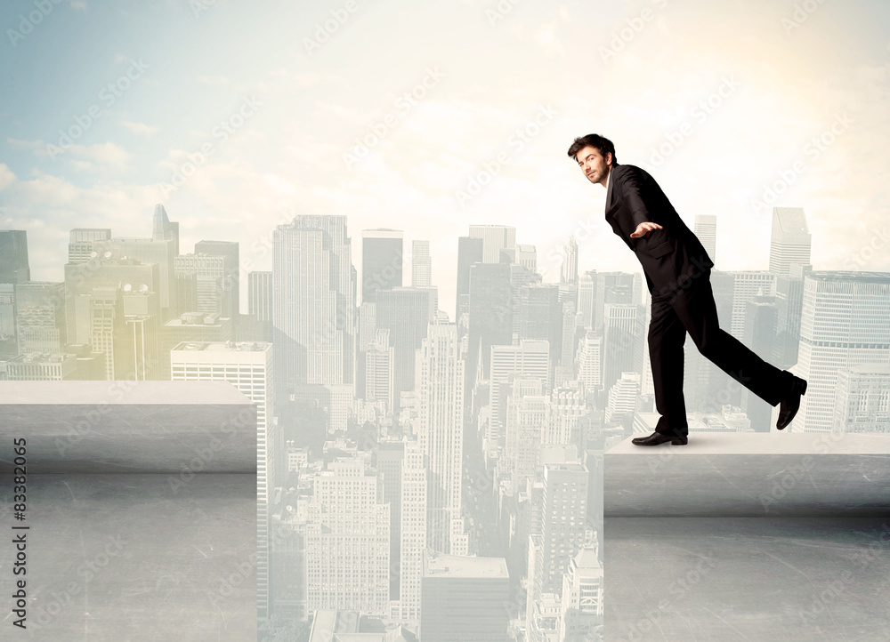 Businessman standing on the edge of rooftop Businessman standing on the edge of rooftop