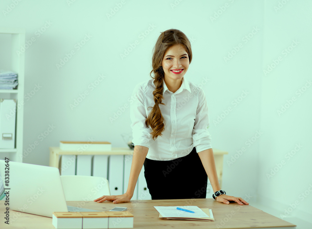 Attractive businesswoman sitting in the office Attractive businesswoman sitting in the office