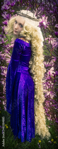 Young woman dressed like Rapunzel with long blond hair.