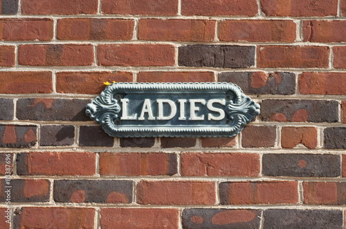Vintage Ladies Sign on brick wall