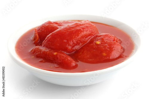 Whole canned tomatoes in white dish. Isolated.