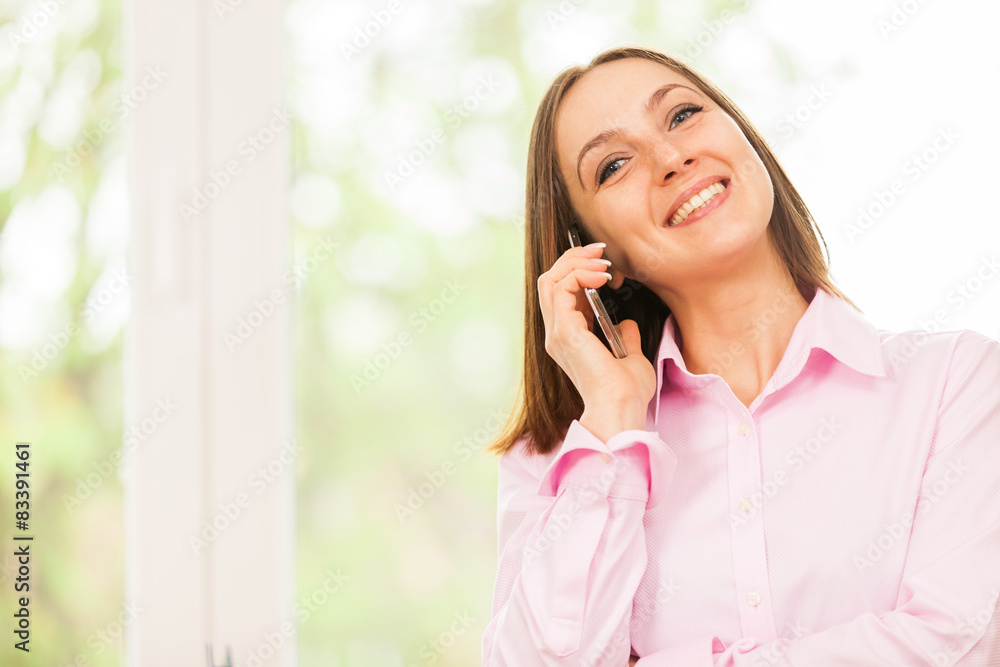 Caucasian smiling business woman is having a phone call Caucasian smiling business woman is having a phone call