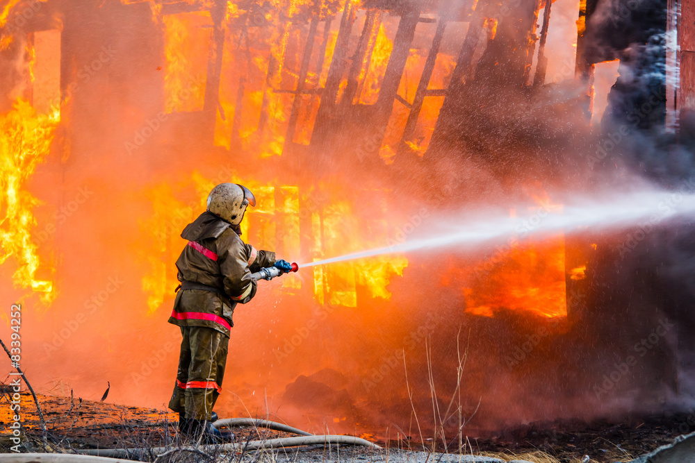 Fototapeta premium Fireman extinguishes a fire