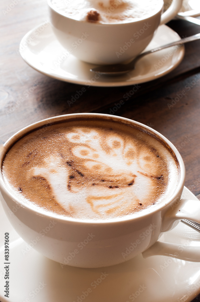Latte' Art Coffee,Cup of latte coffee on wooden background Latte' Art Coffee,Cup of latte coffee on wooden background