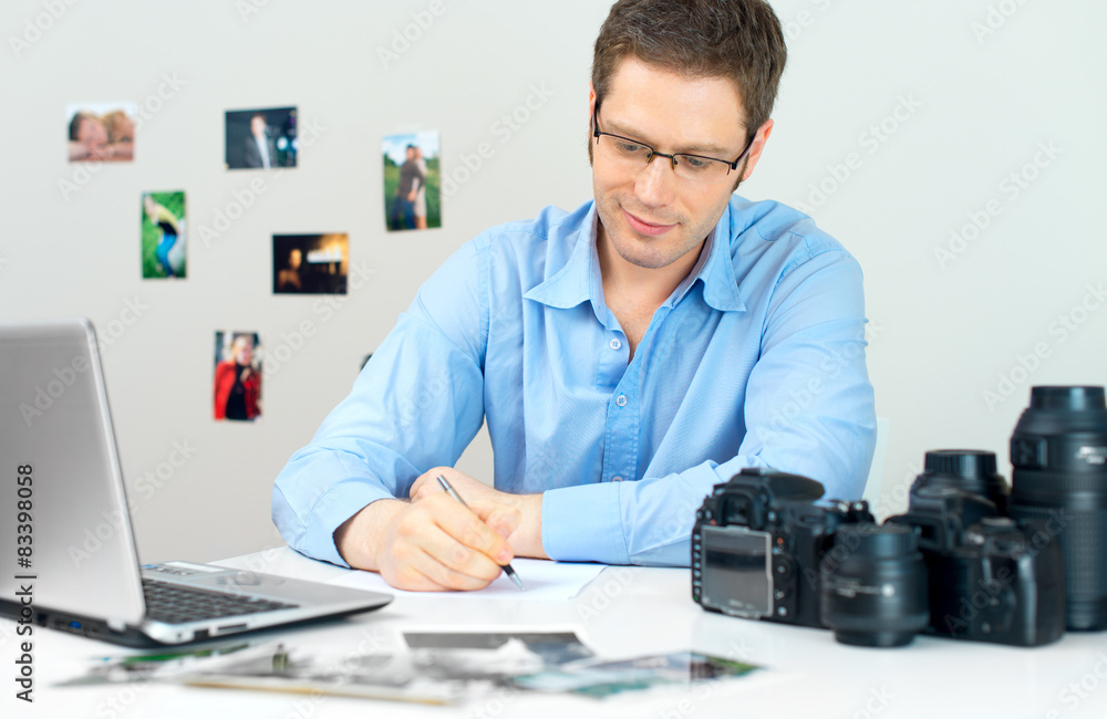 Photographer selecting photos on his computer.