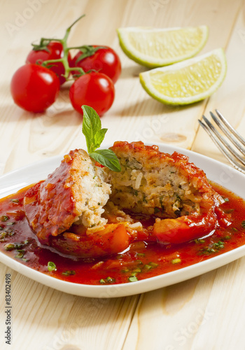 Bell peppers stuffed with meat, rice  and sauce on plate, select