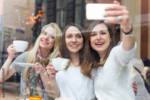 Canvas Print Women taking a selfie in a cafe in Copenhagen