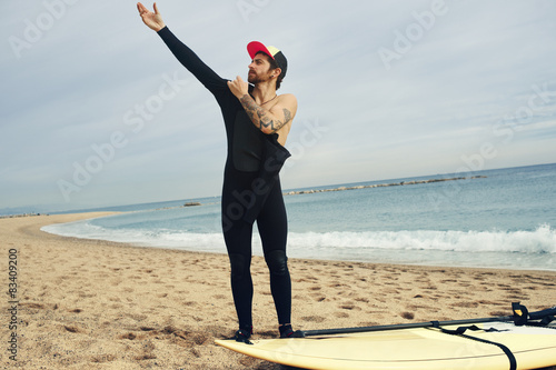 Canvas Print Portrait of a young surfer sports man wearing surfing neoprene