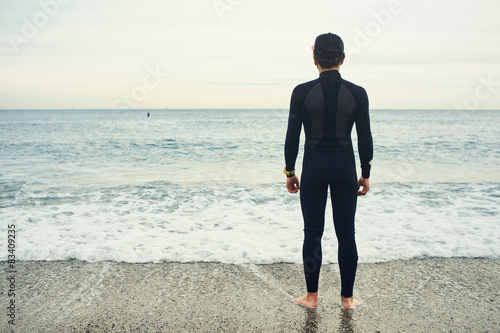 Εκτύπωση καμβά Surfer sports man wearing surfing neoprene waterproof suits