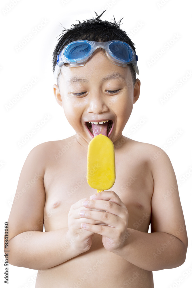 Cheerful boy enjoying ice cream in studio Cheerful boy enjoying ice cream in studio