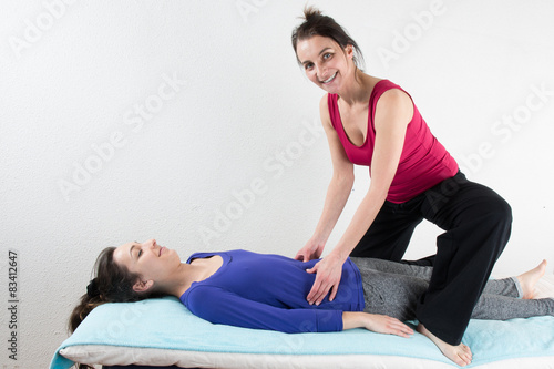 Woman legs massage at spa center given by a woman therapist