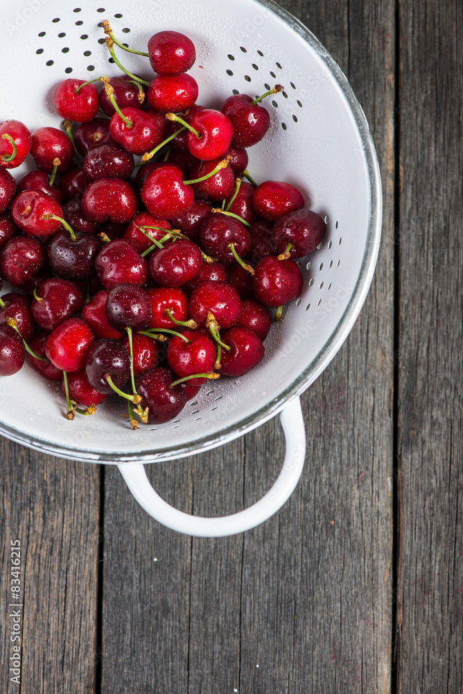 Fresh clean organic ripe cherries in colander Fresh clean organic ripe cherries in colander