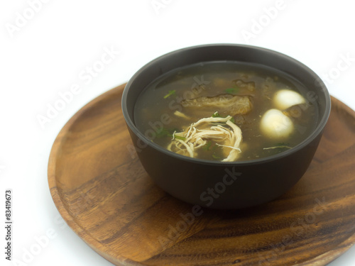 Fish maw soup on the wooden tray in white background (Thai food)
