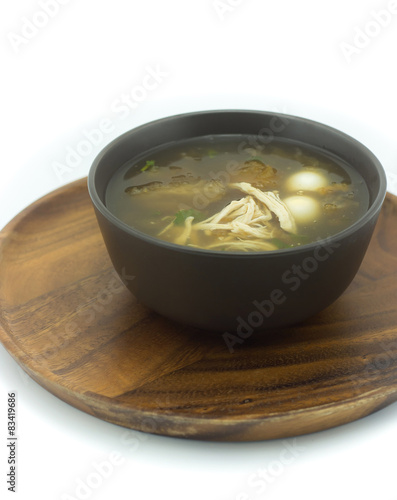 Fish maw soup on the wooden tray in white background (Thai food)