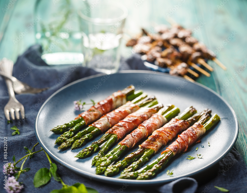 Grilled green asparagus wrapped in bacon