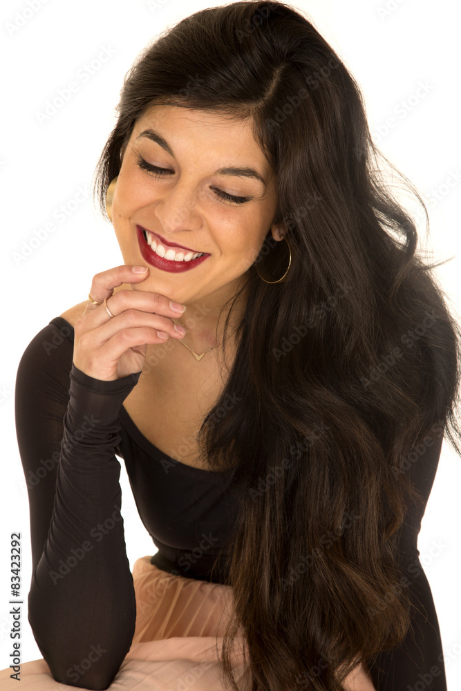 Fototapeta premium Pretty brunette female sitting smiling hand on chin looking down