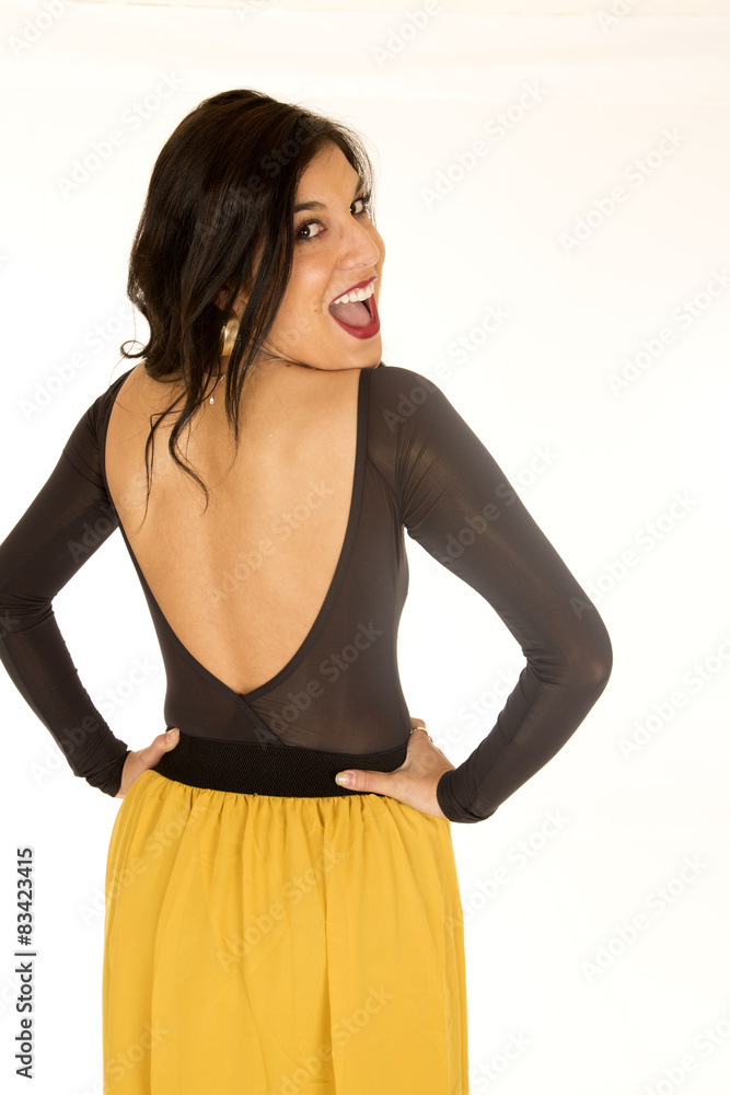 Brunette woman standing bare back looking over her shoulder Brunette woman standing bare back looking over her shoulder