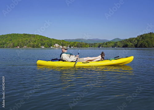 Older man in Kayak on Mountain Lake