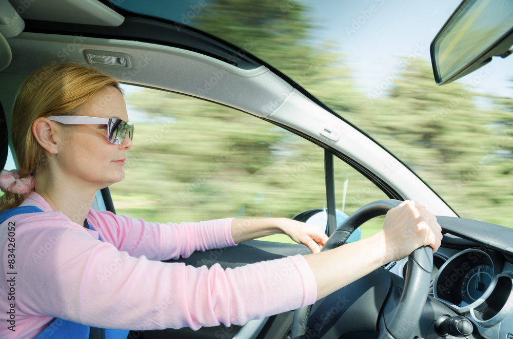 Pretty woman in sunglasses driving fast car Pretty woman in sunglasses driving fast car