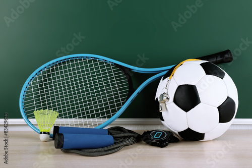 Sports equipment on blackboard background