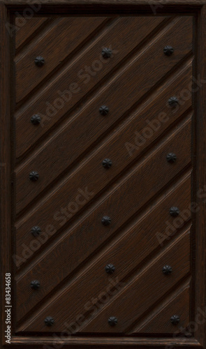 detail of wooden door with metal decorations