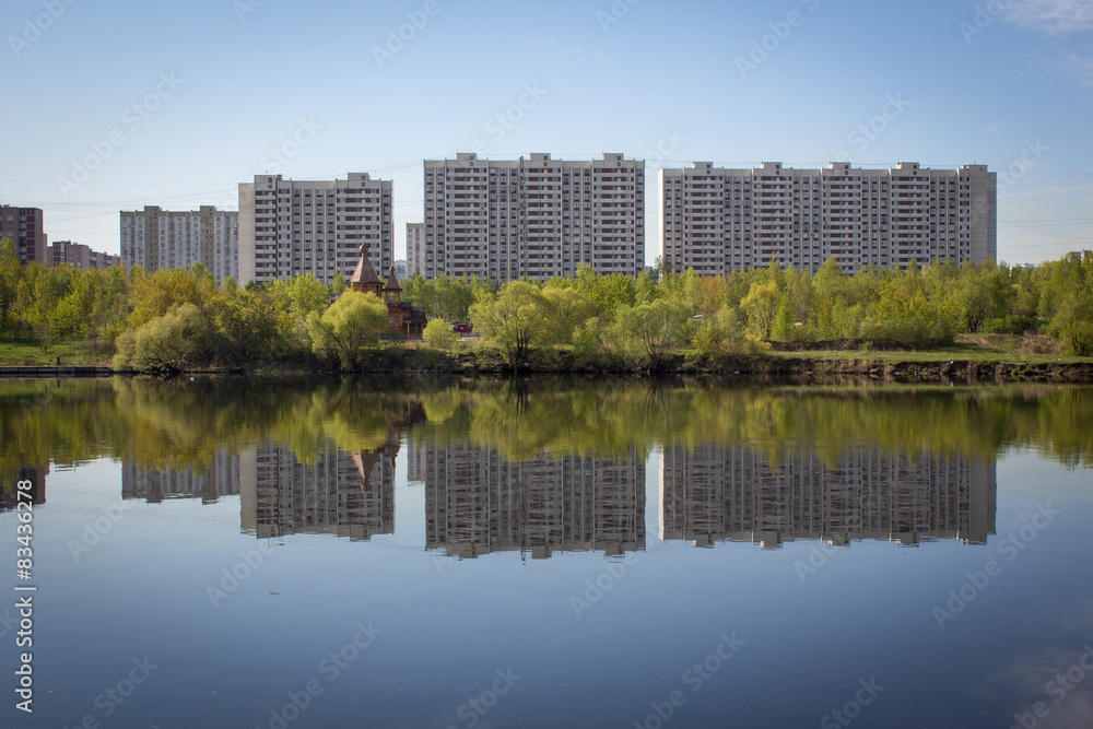 multi-storey buildings are reflected in the water