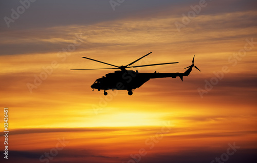 Picture of helicopter at sunset. Silhouette of helicopter on sun © es0lex