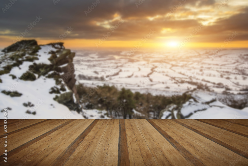 Stunning Winter sunset landscape from mountains looking over sno