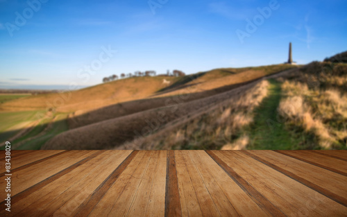 Ancient chalk white horse in landscape with wooden planks floor photo