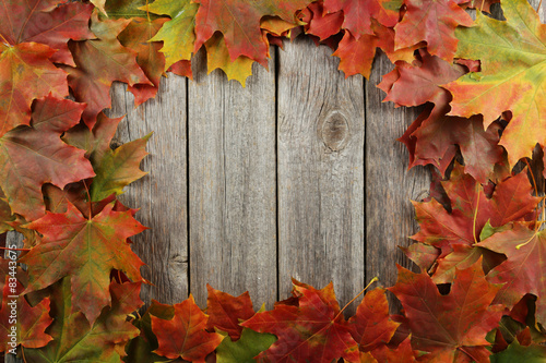 Autumn leafs frame on grey wooden background