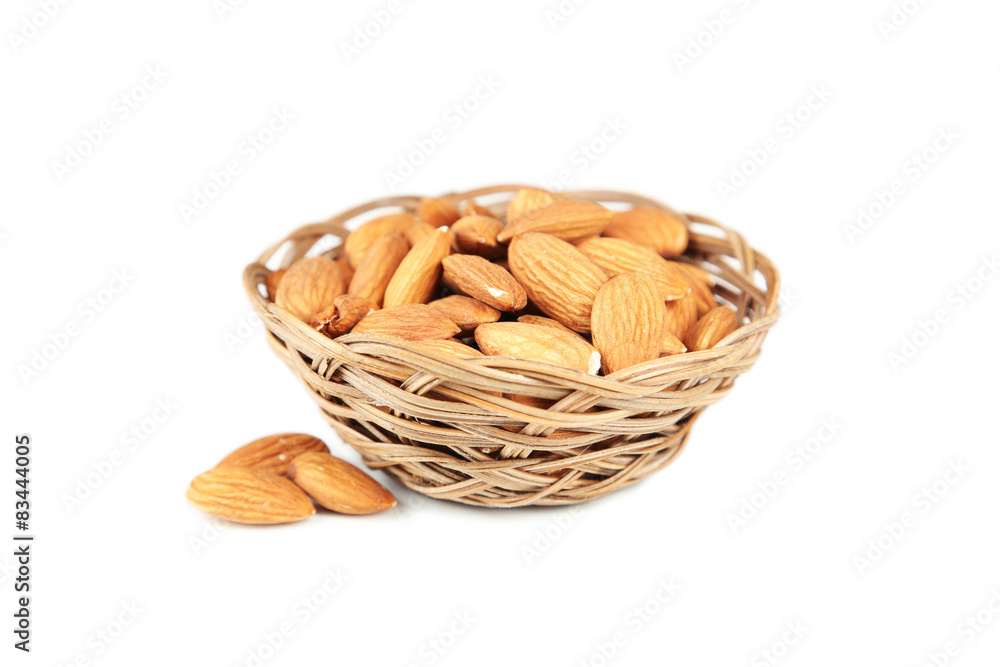 Almonds in basket isolated on white Almonds in basket isolated on white