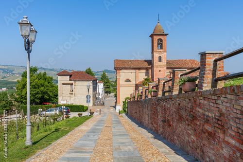 Brick wall and small church in Italy.
