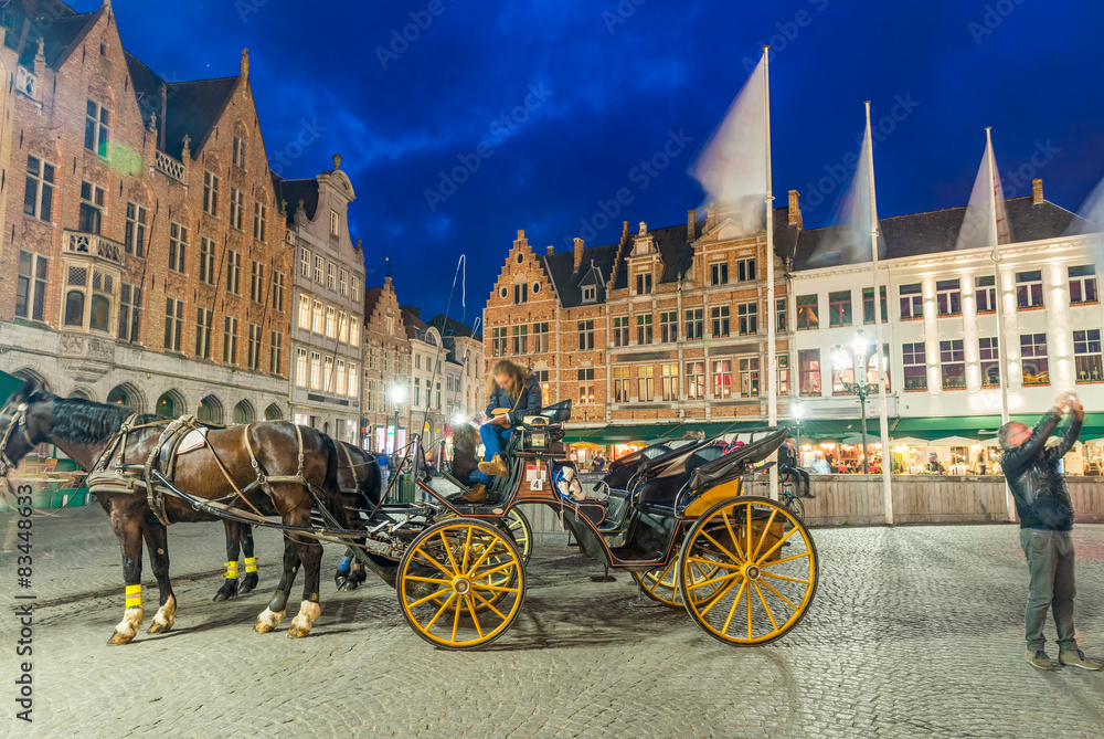 Night view of Horse Carriage in Bruges main square