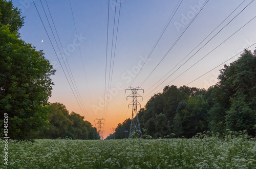 Summer evening landscape with high-voltage power line