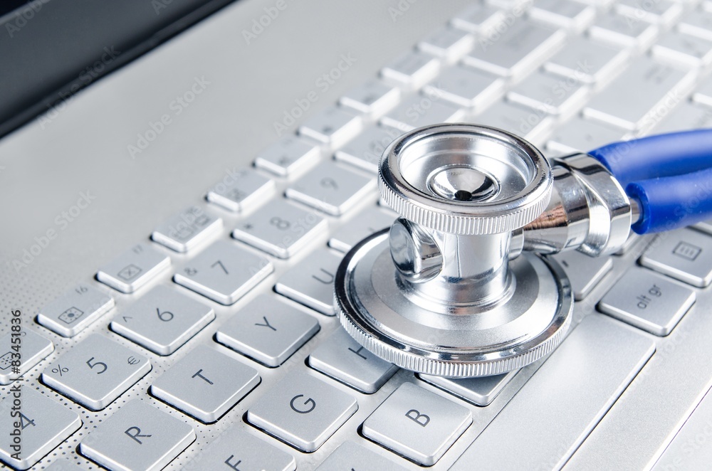 Diagnosis and repair of computers. Stethoscope on laptop Diagnosis and repair of computers. Stethoscope on laptop