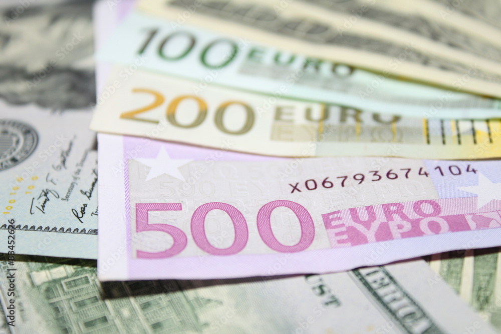 Background of euro and dollar bills. Shallow focus. Background of euro and dollar bills. Shallow focus.