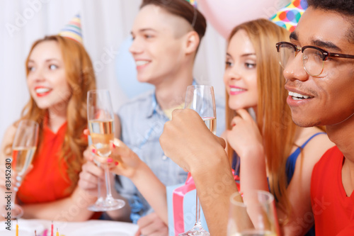 Young people celebrating a birthday sitting at the table