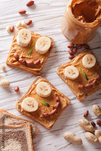 Kids sandwiches with peanut cream and banana. top view