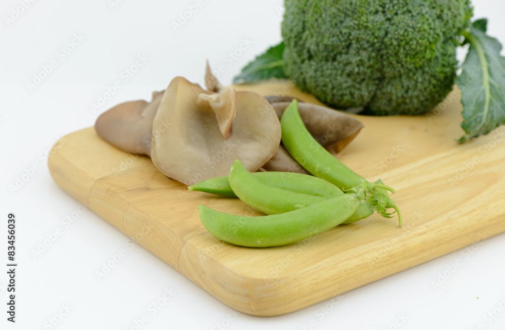 sugar pea, Jew's Ear Mushroom broccoli on cutting board isolated sugar pea, Jew's Ear Mushroom broccoli on cutting board isolated