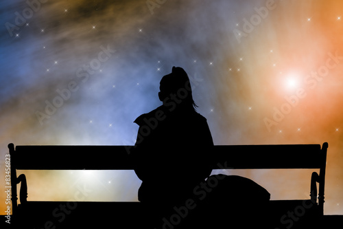Girl watching the Moonrise on a starry skies.