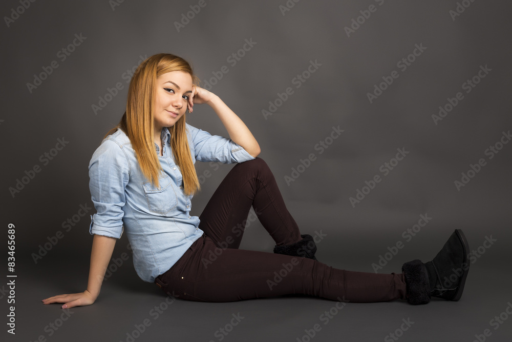 Smiling teenage girl on the floor posing Smiling teenage girl on the floor posing