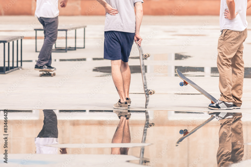 handsome guys with skateboard at freestyle park outdoors