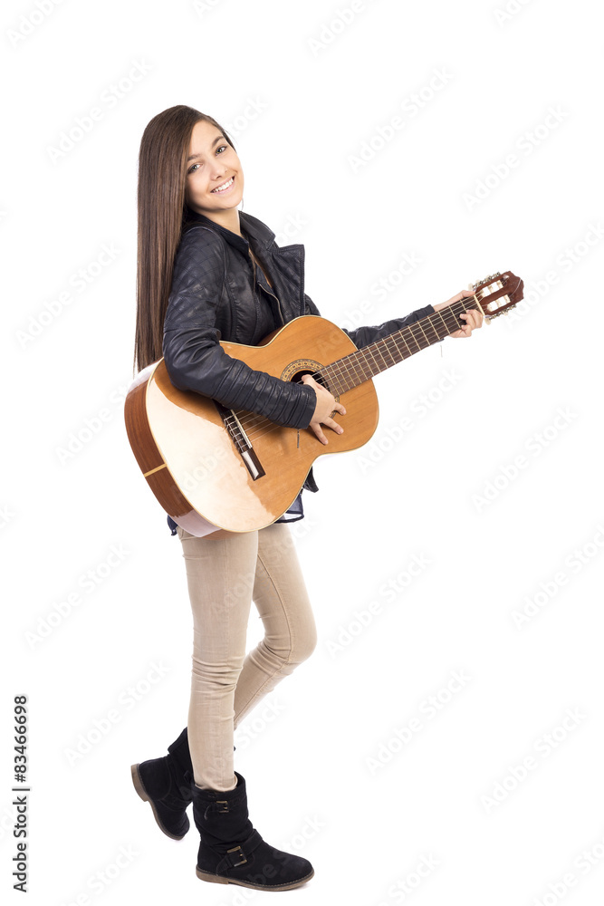 Full length portrait of happy teenage girl playing guitar