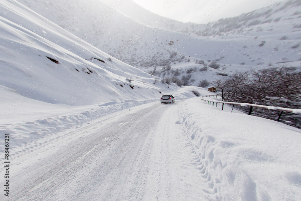 road with a car in winter in the mountains