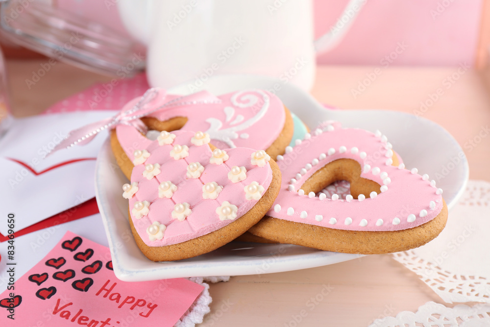 Heart shaped cookies for valentines day on plate, on color wooden background Heart shaped cookies for valentines day on plate, on color wooden background