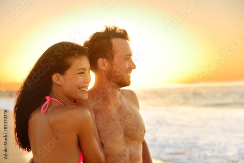 Romantic happy couple lovers on beach honeymoon © Maridav