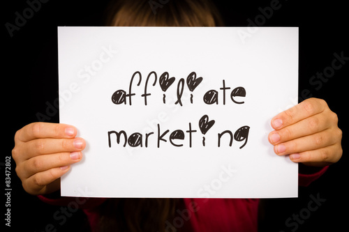 Person holding affiliate marketing sign
